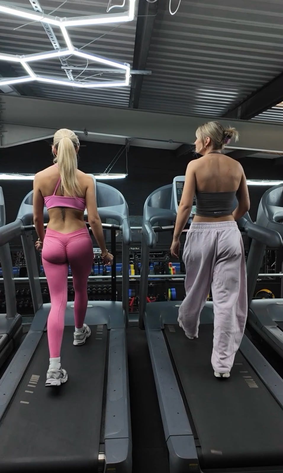 Two members walking side by side on treadmills at The Steel Yard.
